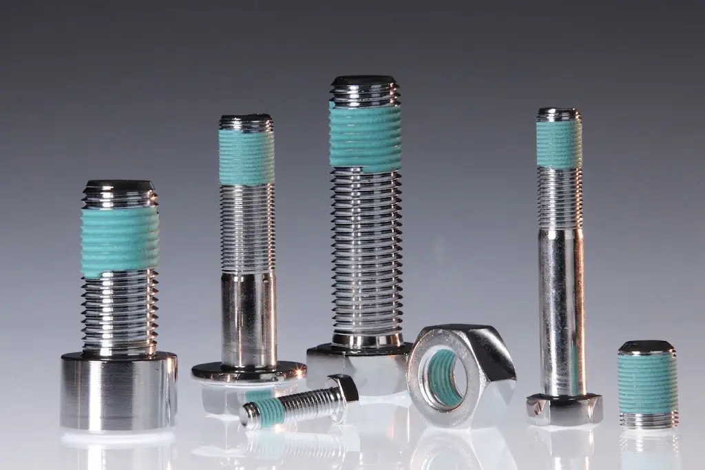 APET Thread Sealing Coating — turquoise dry seal coating on industrial bolt